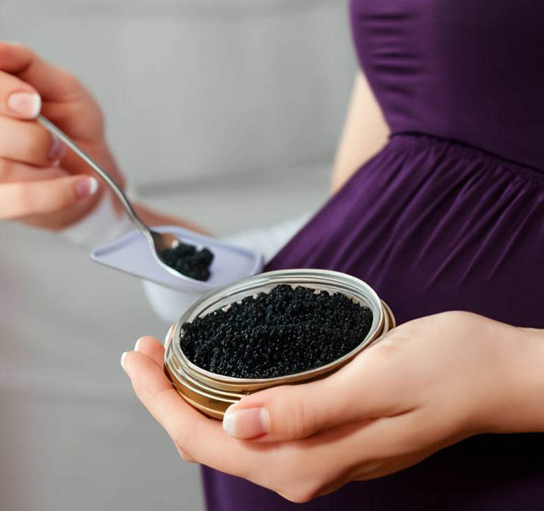 Pregnant woman eating black caviar, photo by Gourmet Food Store