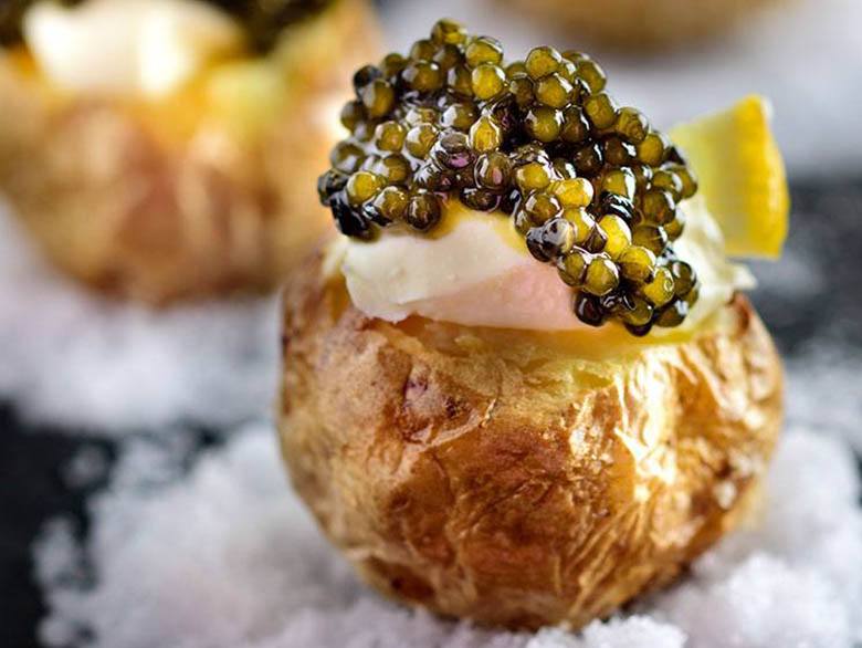 Black caviar served  with potato and cream, photo by Gourmet Food Store